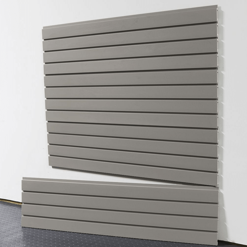 Weathered grey slatwall panels installed on a garage wall, featuring a smooth modern finish and durable interlocking design by Oura Decor.