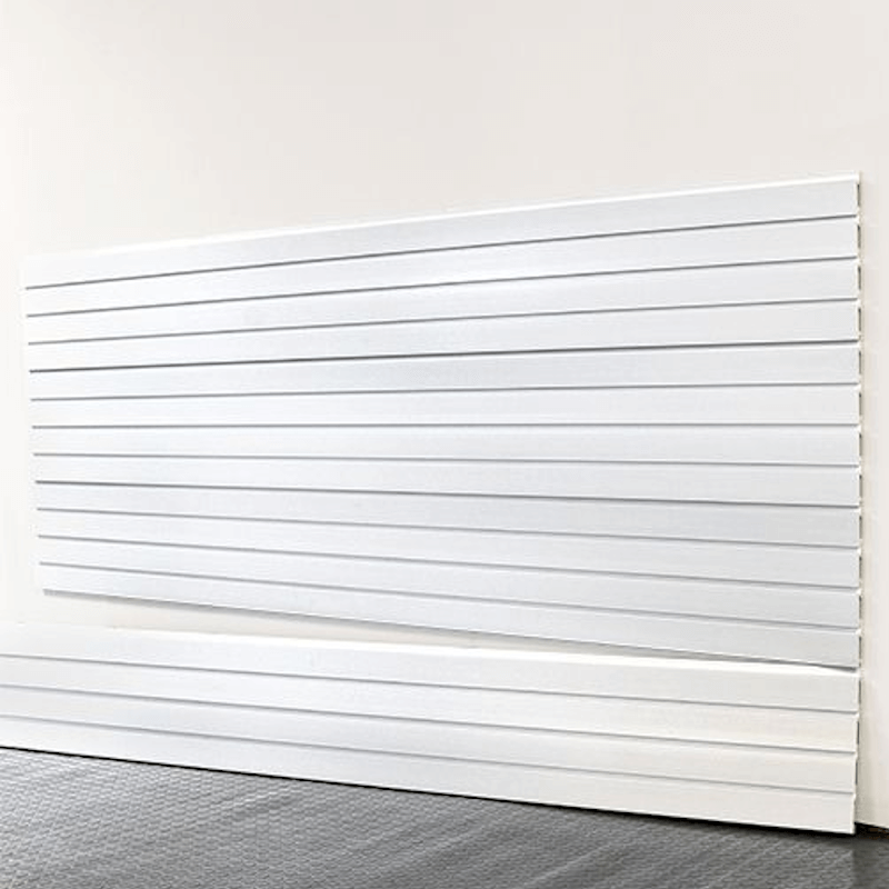 8-foot bright white slatwall panels installed on a garage wall, showcasing a clean, seamless design and durable interlocking construction by Oura Decor.
