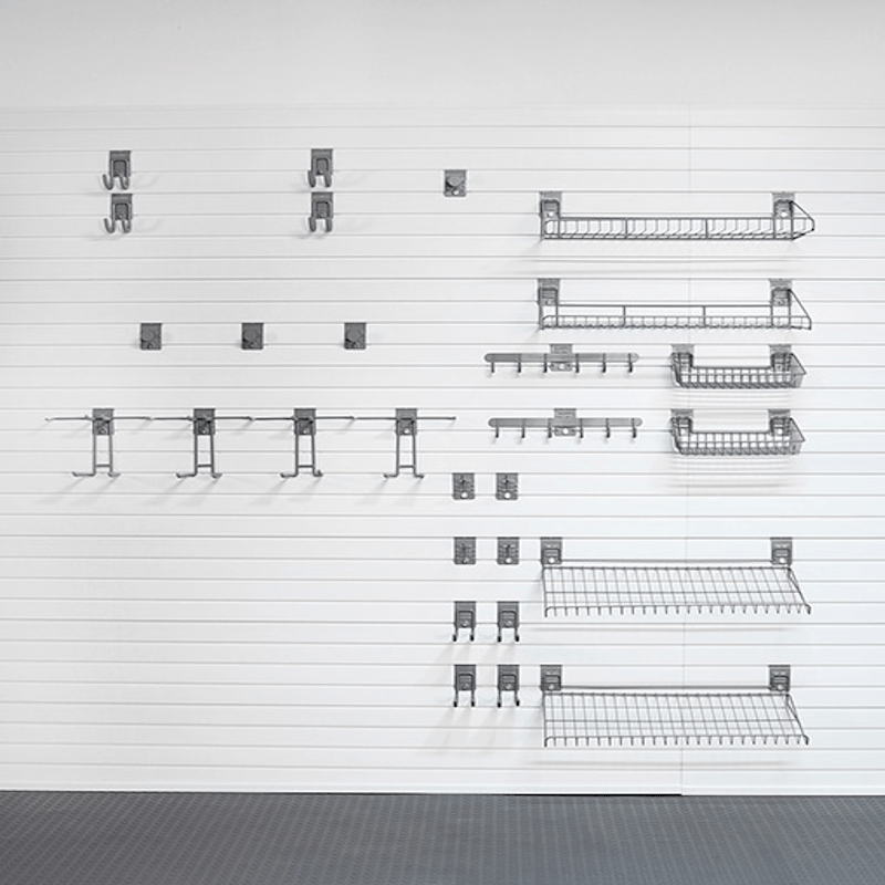 A set of silver metal wire shelving and wall-mounted brackets arranged in a grid pattern on a white paneled wall.
