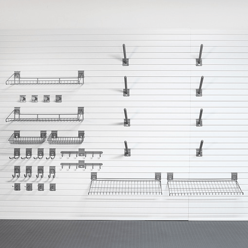 A set of dark gray metal wall-mounted shelving and hook accessories arranged on a white pegboard wall, with a dark gray floor visible at the bottom.