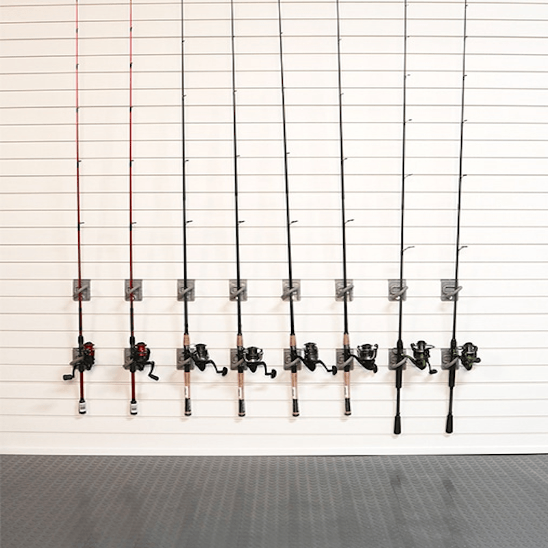 Eight fishing rods with different colored lines and black spincast reels mounted on a white slatwall.