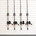 Four fishing rods with black reels mounted on a white slatwall storage system.