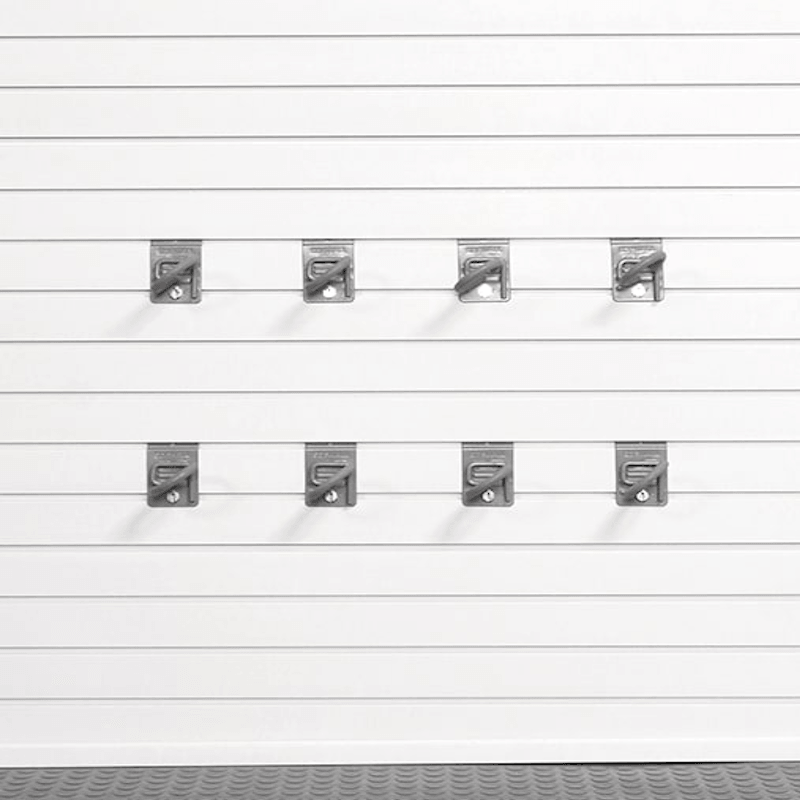 Six gray plastic garage door hooks arranged in two rows of three on a white slatted garage door, with a gray textured surface visible along the bottom edge.