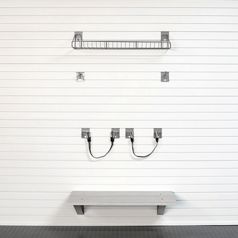 A wall-mounted shelving system shown on a white slatted wall, including two wire baskets, four wall hooks with cords, and a lower shelf, all in a clean studio-style presentation.
