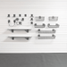 A wall-mounted storage organizer set including two white shelves with dark gray brackets, multiple gray wire baskets in different sizes, and several gray hooks, arranged against a white paneled wall.