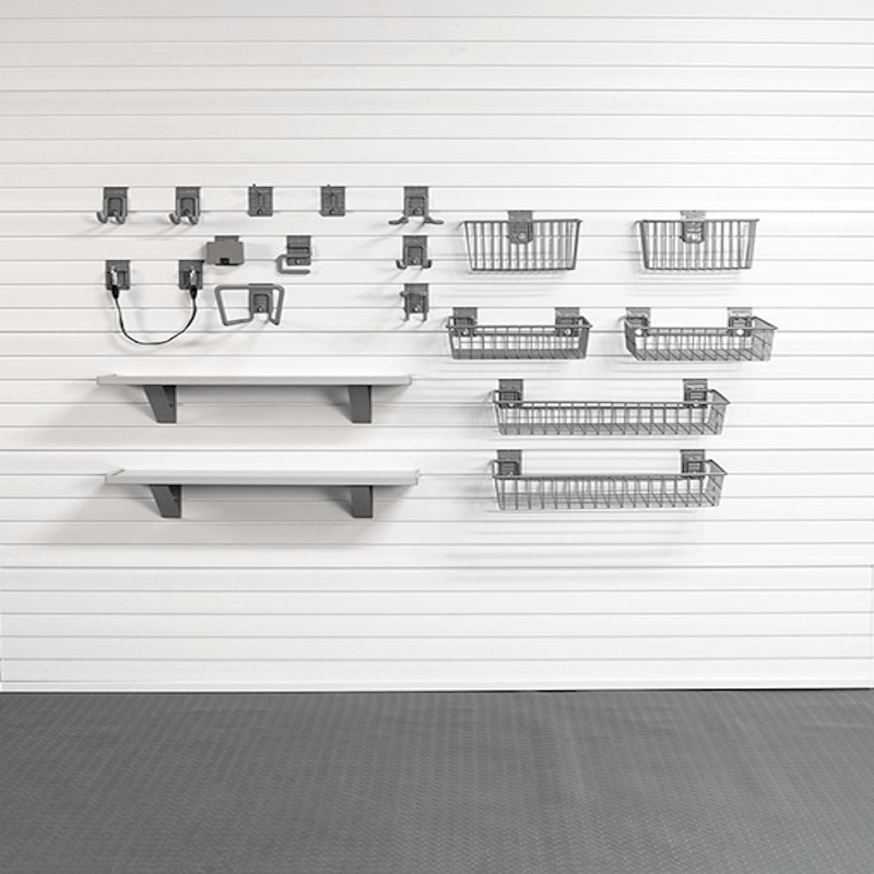 A wall-mounted storage organizer set including two white shelves with dark gray brackets, multiple gray wire baskets in different sizes, and several gray hooks, arranged against a white paneled wall.