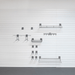 A set of dark gray metal wall-mounted shelves and hooks arranged on a white slatwall panel, with a dark gray floor visible at the bottom.