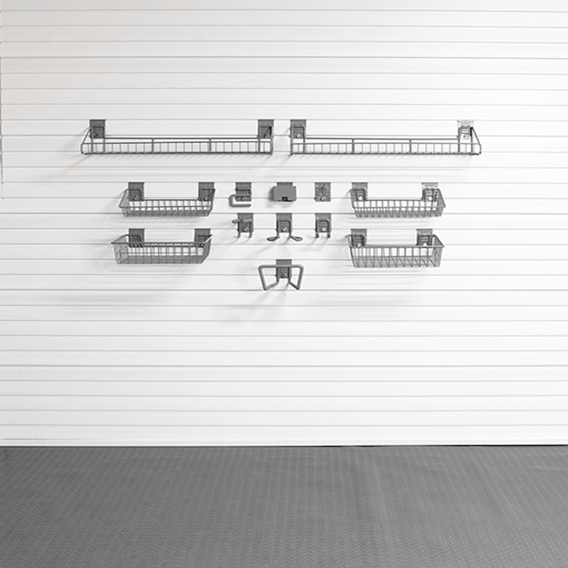 A set of dark gray metal wire baskets and hooks mounted on a white slatted wall, with a gray textured floor below.