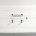 A gray metal garage door shelf and two matching wall brackets mounted on a white slatted garage door, with a gray floor visible at the bottom.