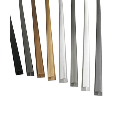 Six long, narrow metal or wood trim pieces shown upright on a plain white background, in black, dark gray, tan, light wood, silver, and white finishes.