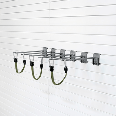 A wall-mounted metal rack with four horizontal bars and four green hanging straps, shown attached to a white slatwall.