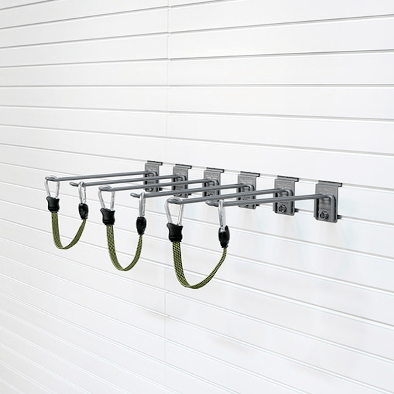 A wall-mounted metal rack with four horizontal bars and four green hanging straps, shown attached to a white slatwall.
