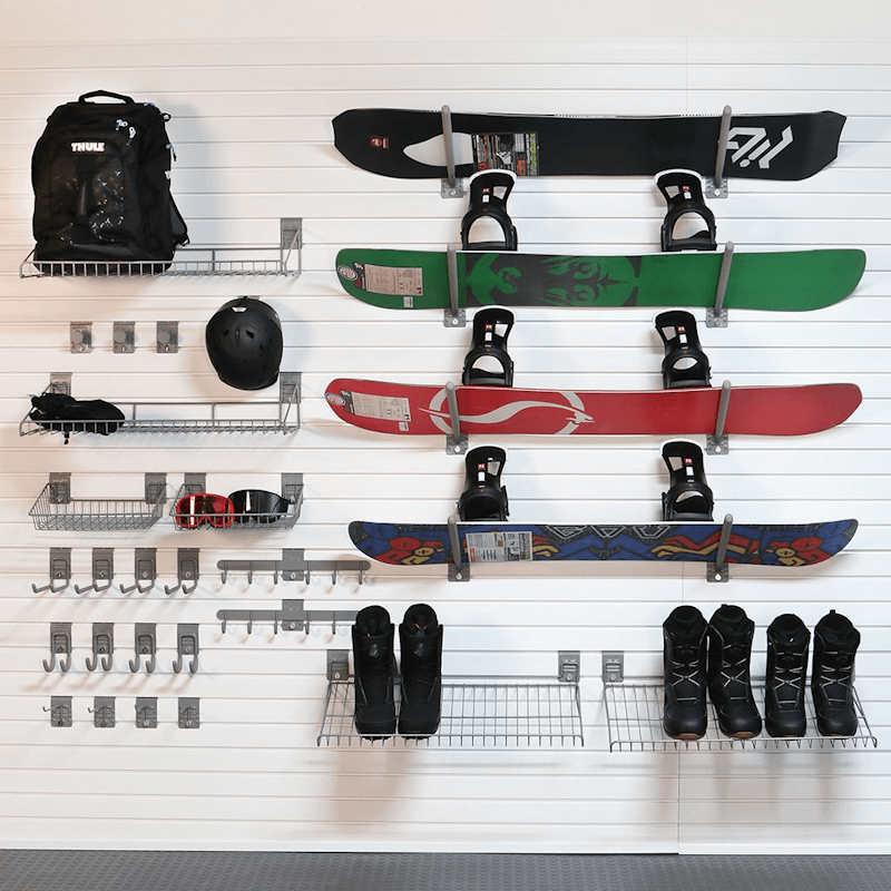 StoreWALL Heavy-Duty Winter Sports Slatwall System Snowboarding showing the snowboard holders, along with the hooks and boot holdings for this wall storage solution