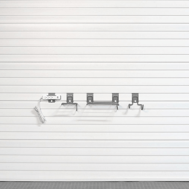 Basic Tool Storage Bundle configuration illustrating minimal essential hooks, shelves, and a power strip bracket on a white slatwall.