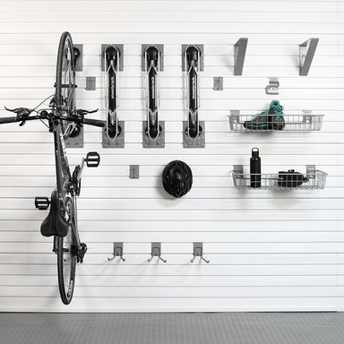 Staged display of a bicycle securely mounted vertically using the Steadyrack system, with cycling gear organized in the accompanying baskets.