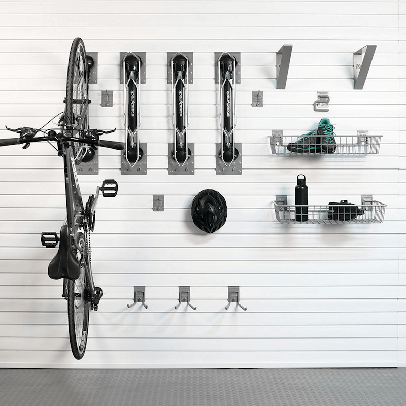 Staged display of a bicycle securely mounted vertically using the Steadyrack system, with cycling gear organized in the accompanying baskets.
