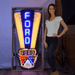 Massive Ford Jubilee Crest neon sign by Neonetics shown with a person to demonstrate the nearly 5-foot scale for garage decor.