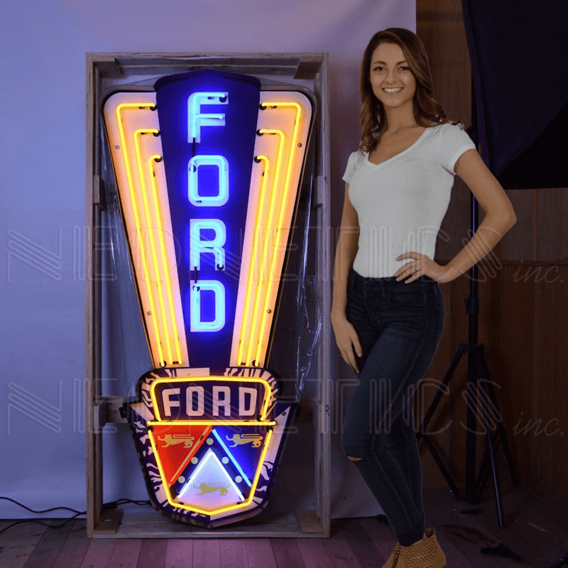 Massive Ford Jubilee Crest neon sign by Neonetics shown with a person to demonstrate the nearly 5-foot scale for garage decor.