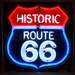 Neonetics Historic Route 66 neon sign in black shaped steel can with red, white, and blue hand-blown glass tubing.