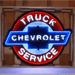 Neonetics Chevy Truck Service neon sign in shaped black steel can with red, white, and blue glass neon.