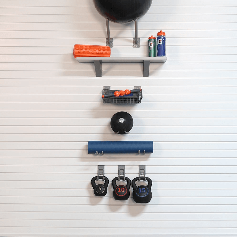 Minimalist home gym setup using the Basic Bundle, demonstrating a small, neatly organized wall area for a yoga mat and light hand weights.