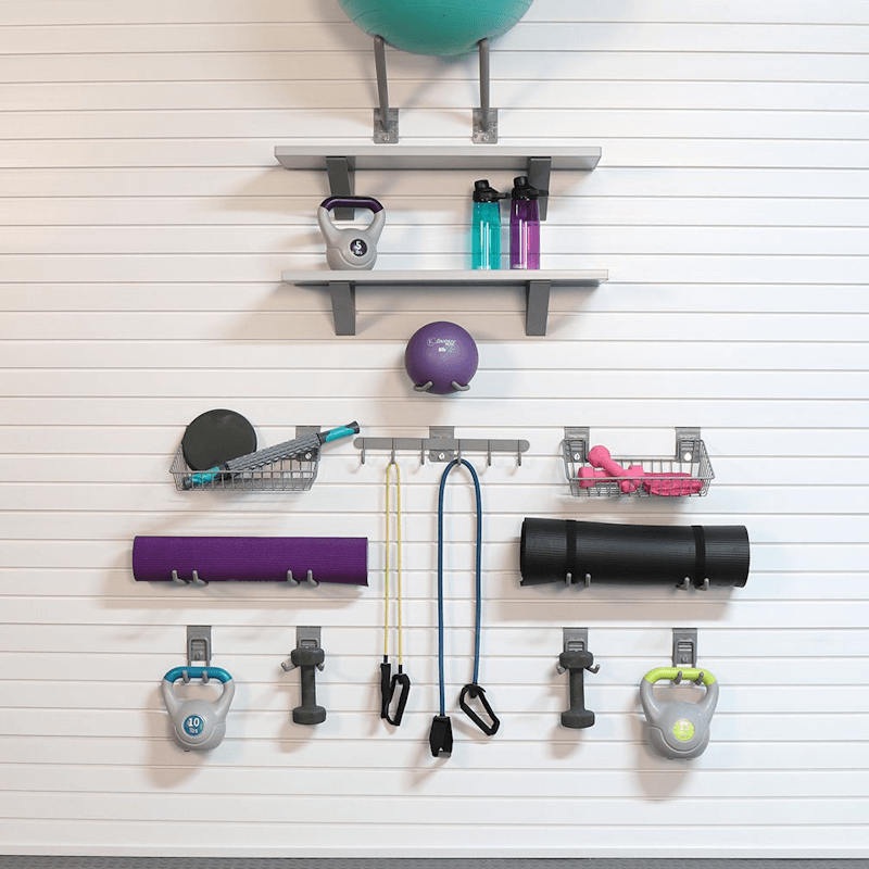Staged photo of a dedicated fitness corner, utilizing the Select Bundle's barnwood shelves and hooks to keep essential workout gear off the floor.