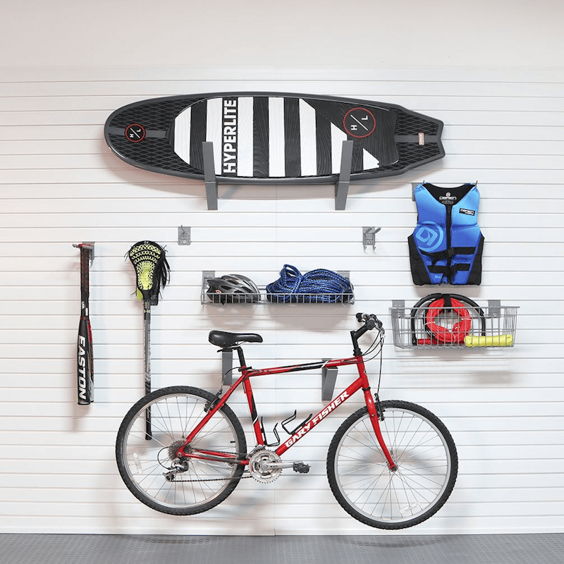 Tidy sports gear station utilizing the Select Bundle, displaying a bike helmet, pump, and cycling shoes organized on a central wall section.